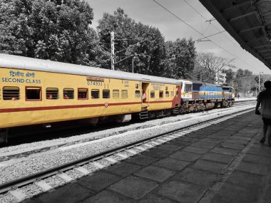 Mandya, Karnataka, India-Feb 12, 2023: Closeup of beautiful Mandya Railway Station and Electric train moving on a track.