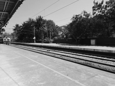 Mandya, Karnataka, India-Feb 12, 2023: Closeup of beautiful Mandya Railway Station and Electric train moving on a track.