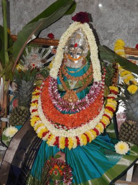 Bangalore, Karnataka, India-Aug 05, 2022: Closeup of beautiful goddess Vara Mahalakshmi decoration with flowers, fruits