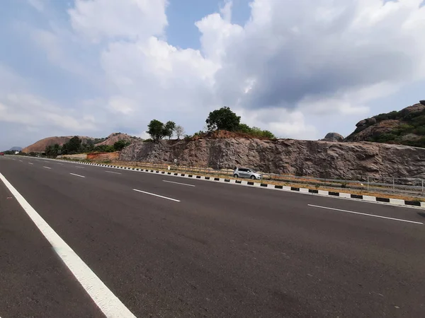 stock image Ramanagar, Karnataka, India-Apr 25, 2023: Closeup of beautiful Ramanagara NH275 new highway road and Ramadevara Hill.