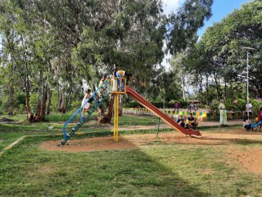 Bangalore, Karnataka, Hindistan-10 Haziran 2023: Parkta ve Machohalli Ormanı Kapısı 'nda birlikte oynayan güzel ve gerçek çocukların spor ekipmanlarına yakın çekim