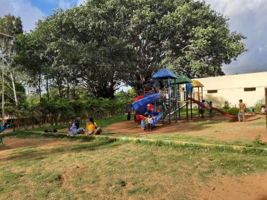 Bangalore, Karnataka, Hindistan-10 Haziran 2023: Parkta ve Machohalli Ormanı Kapısı 'nda birlikte oynayan güzel ve gerçek çocukların spor ekipmanlarına yakın çekim