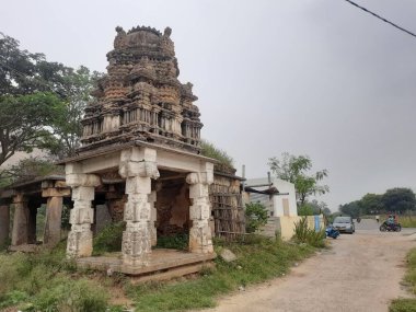Savanadurga, Karnataka, Hindistan 'da Veerabhadreshwara Swamy Tapınağı' nın aydınlık, eski kule ve büyük taş tepe ve halka açık güzel dini binasının kapatılması..