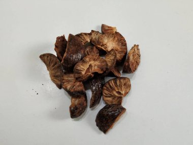 Group of Sliced and Dried Betel/Areca nut. Dried betel nut (Areca catechu) is the fruit of the areca palm (Areca catechu), Usually for chewing, a few slices of the nut are wrapped in a betel leaf along with calcium hydroxide (slaked lime) clipart