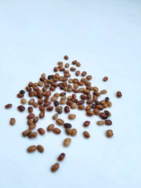 Pile and Texture of Hurali Kalu or Horse Gram isolated on white background. Closeup of horse gram seeds which is used in cooking. clipart