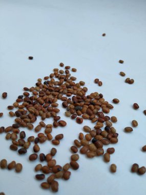 Pile and Texture of Hurali Kalu or Horse Gram isolated on white background. Closeup of horse gram seeds which is used in cooking. clipart