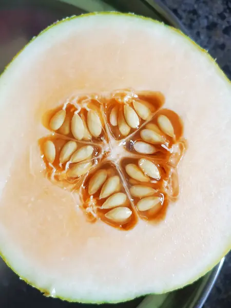Closeup of Muskmelon Fruit Seeds and Slice texture Background