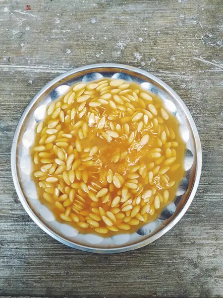 Closeup of a Group of Muskmelon Fruit Seeds in a Steel Plate. Musk Melon Fruit seeds texture