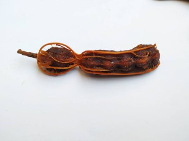 Tropikal demirhindi meyvesine yakın çekim. Kabuğu olmadan soyulmuş, görünür tohumlar ve iç posası var. Beyaz arkaplanda izole