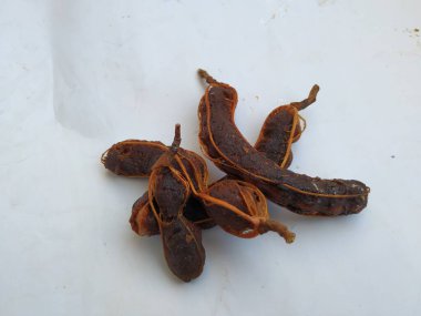 Tropikal demirhindi meyvesine yakın çekim. Kabuğu olmadan soyulmuş, görünür tohumlar ve iç posası var. Beyaz arkaplanda izole