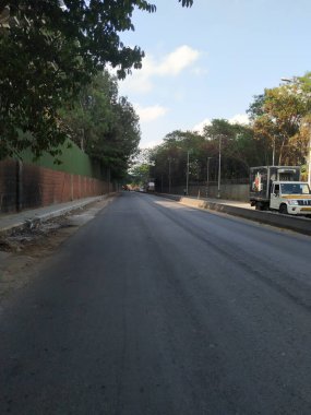 Bangalore, Karnataka, India-April 20 2020: Closeup of beautiful asphalt road view of BMTC Bus Routes from Goraguntepalya to Hebbal. clipart