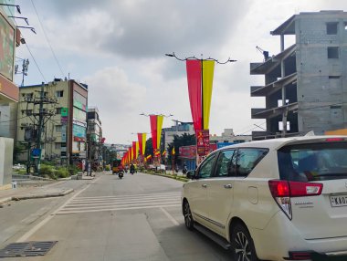 Bangalore, Karnataka, India-November 4, 2024: Beautiful decoration using yellow and red color cloth to celebrate Kannada Rajyotsava on roadside of the Nagarabhavi. clipart