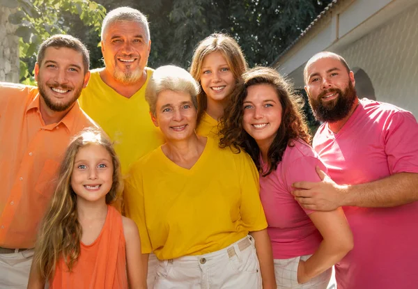 Portrait of a big happy family together in colorful t-shirts