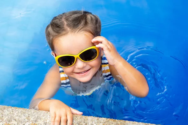 stock image Portrait of a happy child in sunglasses in the water