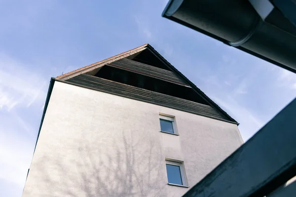 stock image looking up from below at the triangular roofs of the white houses