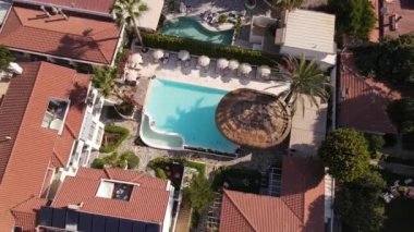 Beautiful drone footage of panoramic view of hotel pool and Oludeniz city, summer time . High quality FullHD drone footage