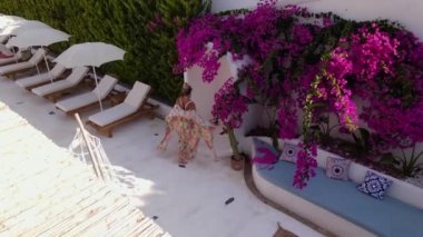 Aerial view of woman have a shower in hotel, beautiful pool, Oludeniz, Turkey. High quality FullHD footage