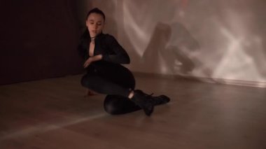 Sexy girl with choker dancing on orange neon background in studio, slow-motion, . High quality FullHD footage