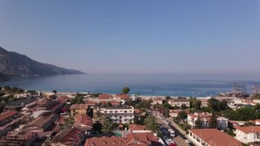 Aerial view on seashore with luxury Hotel with mountains background, Oludeniz, Turkey. High quality FullHD drone footage