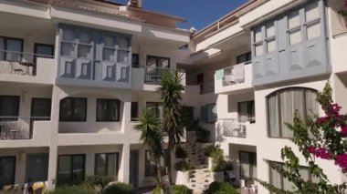 Beautiful aerial panoramic view of hotel pool and Oludeniz city, summer time . High quality FullHD drone footage