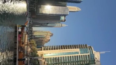 Panoramic view of Dubai, beautiful buildings, river, sunlight day, vertical video. High quality FullHD footage