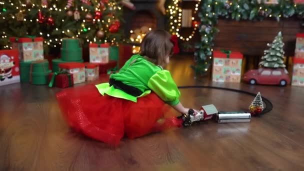 Little Girl Playing Colorful Train Toy Room Decorated Christmas Christmas — Vídeo de Stock