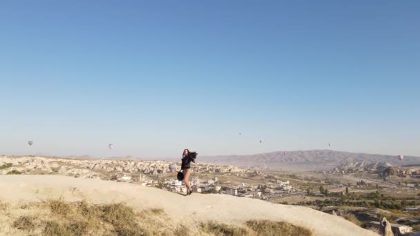 Молодая Женщина Шляпе Черной Куртке Идущая Долинам Заката Каппадокии Турецкое — стоковое видео