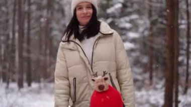 Cute girl with little boy smiling and playin in winter snow forest in Austria, 4k footage. High quality 4k footage