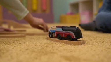 Child playing with a toy train. High quality FullHD footage