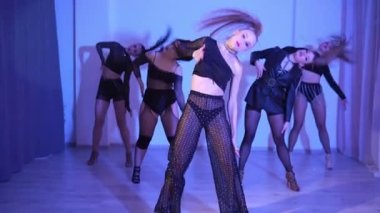 High heels dance five girls in neon light blue studio, sexy hot emotions. High quality FullHD footage