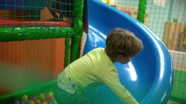 The happy smiling boy climbs the slide wrong. High quality FullHD footage