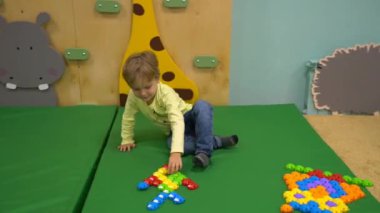 The boy is playing a mosaic and learning colors. High quality FullHD footage