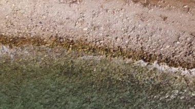 Waves hitting rocks on the beach . High quality 4k footage