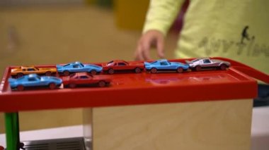 The child plays with toy cars and the road. High quality FullHD footage