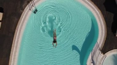 A woman dives in a pool in a swimsuit. High quality FullHD footage