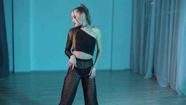 トップダンスとダンスパンツのセクシーな女達がライトアップされたスタジオルームで踊り始める 高品質のフルHd映像 — ストック動画