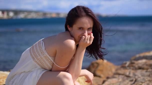 Beyaz Elbiseli Çıplak Ayaklı Taşın Üzerine Oturan Kız Kameraya Bak — Stok video