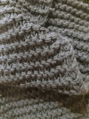 Siyah yüzey, örgü, iplik. Arkaplan tasarımı, fotoğrafçılık. Tekstil, kumaş şablonu, modern 