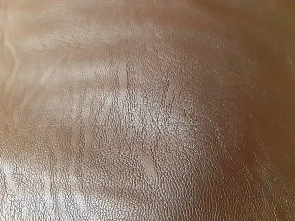 Kahverengi deri yüzey. Arkaplan tasarımı, fotoğrafçılık. Tekstil, kumaş şablonu, modern 