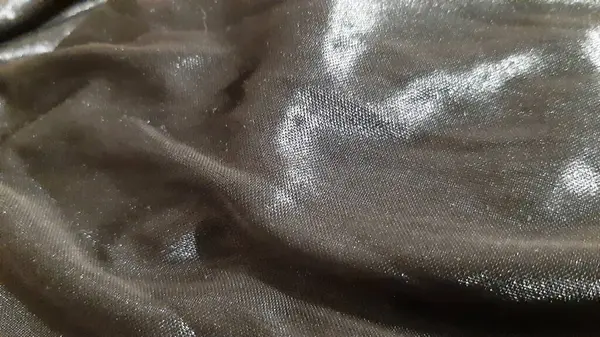 Siyah, karanlık, parlak, lüks bir yüzey. Arkaplan tasarımı, fotoğrafçılık. Tekstil, kumaş şablonu, modern yeni
