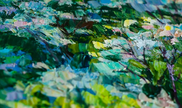 Strokes of oil paints in green and blue colors close-up