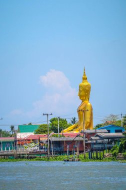 The Buddha statue is near river clipart