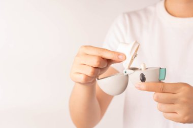 Astım spreyini hazırlayın. Kadın elleri, Tiotropium bromür kapsülünü sprey odasına koyar ve ağızlığı kapatır. İlaç ürünleri COPD ve astımın tedavisinde kullanılır..