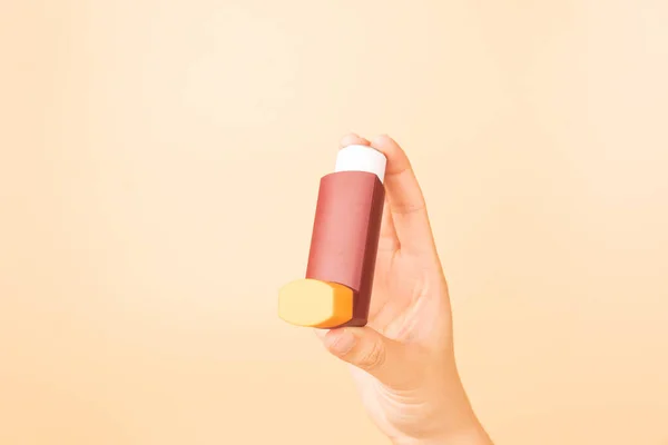 Main Tenant Inhalateur Asthme Brun Sur Fond Orange Produit Pharmaceutique — Photo