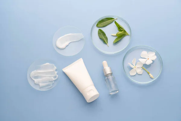 stock image Natural skincare product in laboratory. Cosmetic smears cream texture on glass watch with lotion tube, essential oils bottle and herbal extract. Beauty cosmetic research and development concept.