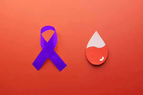 stock image National ITP (Immune thrombocytopenic purpura) awareness month in september. Blood drop shape with purple ribbon on red background.