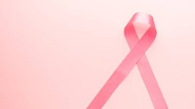 Ekim pankartıyla Göğüs Kanseri Farkındalığı Ayı. Pembe kurdele farkındalık sembolü. Pembe arka plandaki göğüs kanseri hastasını desteklemek için. Kadın sağlığı ve sağlık hizmetleri.