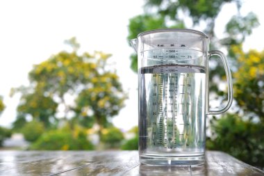 Tahta masadaki temiz plastik sürahide su içeceğiz.