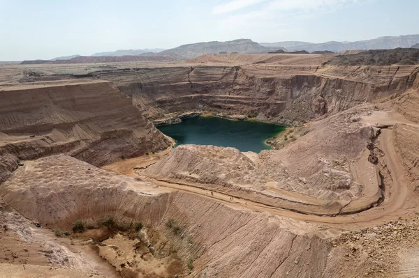 Massive crater in an old copper quarry full of water in the hidden lake in Timna Park, southern Israel