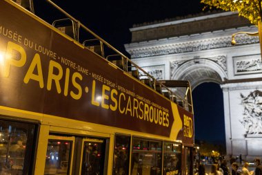 Paris, France - October 26, 2022: Arc de Triomphe and Paris tour bus.